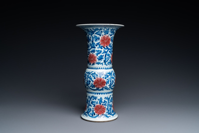 A Chinese blue, white and copper-red 'gu' vase with lotus scrolls, Kangxi