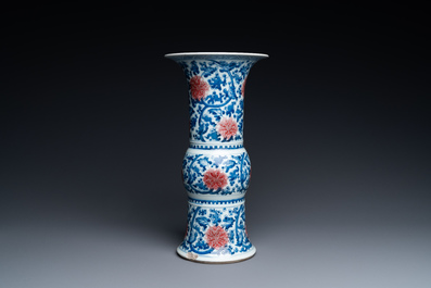 A Chinese blue, white and copper-red 'gu' vase with lotus scrolls, Kangxi