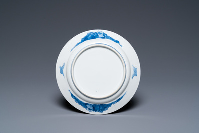 A Chinese blue and white plate with two men in a landscape, Kangxi