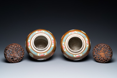 A pair of Chinese famille rose capucin brown-ground jars, Qianlong