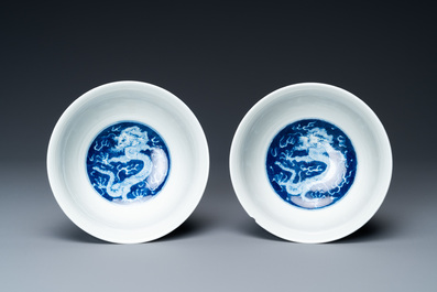 A pair of Chinese blue and white 'dragon' bowls, Kangxi mark, 19/20th C.