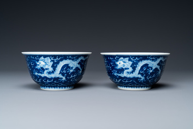 A pair of Chinese blue and white 'dragon' bowls, Kangxi mark, 19/20th C.