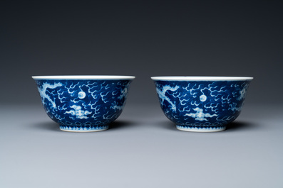 A pair of Chinese blue and white 'dragon' bowls, Kangxi mark, 19/20th C.