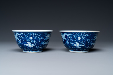 A pair of Chinese blue and white 'dragon' bowls, Kangxi mark, 19/20th C.