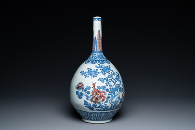 A Chinese blue, white and copper-red bottle vase with a deer and birds among blossoming branches, Daoguang