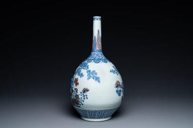 A Chinese blue, white and copper-red bottle vase with a deer and birds among blossoming branches, Daoguang