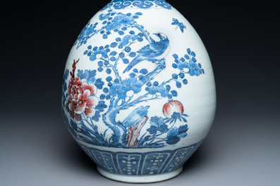 A Chinese blue, white and copper-red bottle vase with a deer and birds among blossoming branches, Daoguang