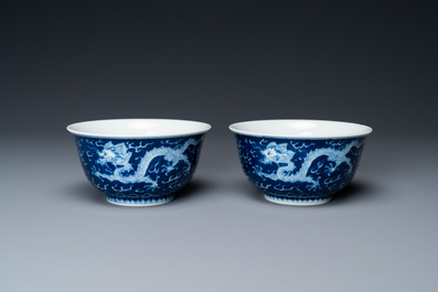 A pair of Chinese blue and white 'dragon' bowls, Kangxi mark, 19/20th C.