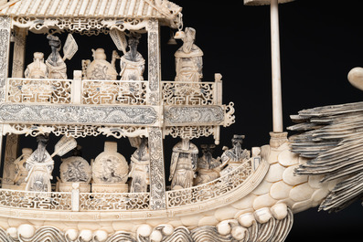A Chinese carved ivory dragon boat on wooden stand, 19th C.