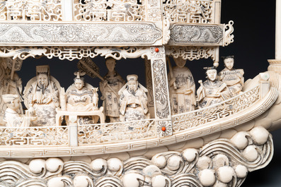 A Chinese carved ivory dragon boat on wooden stand, 19th C.