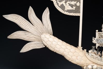 A Chinese carved ivory dragon boat on wooden stand, 19th C.