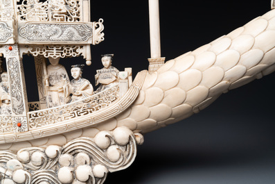 A Chinese carved ivory dragon boat on wooden stand, 19th C.