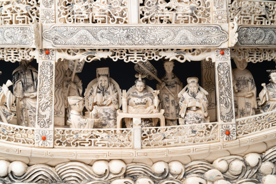 A Chinese carved ivory dragon boat on wooden stand, 19th C.
