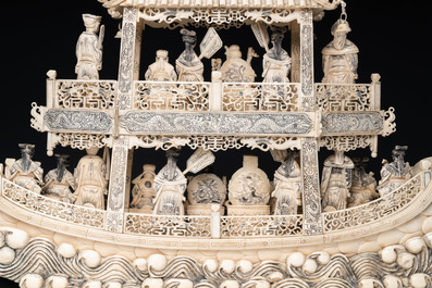 A Chinese carved ivory dragon boat on wooden stand, 19th C.