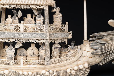 A Chinese carved ivory dragon boat on wooden stand, 19th C.