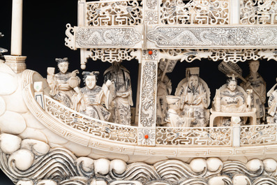 A Chinese carved ivory dragon boat on wooden stand, 19th C.