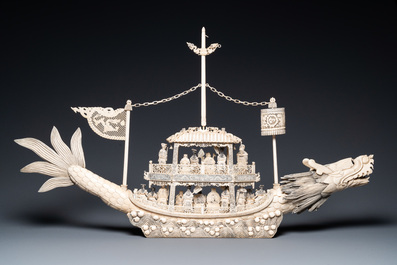 A Chinese carved ivory dragon boat on wooden stand, 19th C.