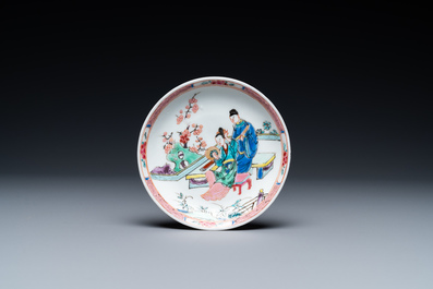 A Chinese famille rose cup and saucer with a couple on a terrace, Qianlong