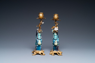 Une paire de lions bouddhistes en porcelaine de Chine en turquoise et aubergine mont&eacute;s comme cand&eacute;labres en bronze dor&eacute;, Kangxi et 19&egrave;me