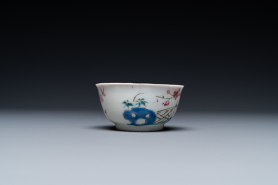 A Chinese famille rose cup and saucer with a couple on a terrace, Qianlong