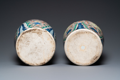 A pair of Chinese wucai 'galloping horses' vases and covers, Transitional period
