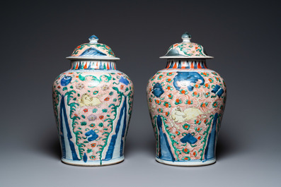 A pair of Chinese wucai 'galloping horses' vases and covers, Transitional period