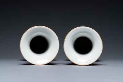 A pair of Chinese famille rose ruby-ground vases, 19th C.