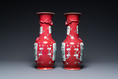 A pair of Chinese famille rose ruby-ground vases, 19th C.