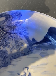 A Chinese blue and white plate with two men in a landscape, Kangxi