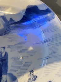 A Chinese blue and white plate with two men in a landscape, Kangxi