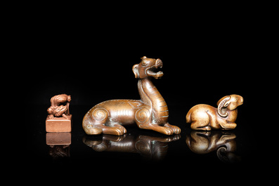 Two Chinese bronze scroll weights and a seal stamp, Qing