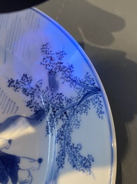 A Chinese blue and white plate with two men in a landscape, Kangxi