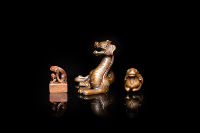 Two Chinese bronze scroll weights and a seal stamp, Qing