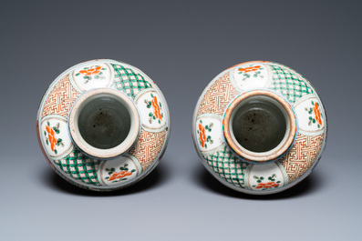 A pair of Chinese famille verte vases on wooden stands, 'hare' mark, 19th C.