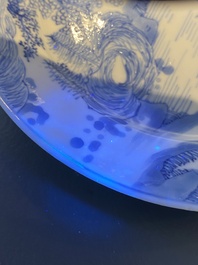 A Chinese blue and white plate with two men in a landscape, Kangxi