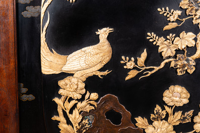A large Japanese wooden screen with a central gilt-lacquered and ivory-inlaid panel, Meiji