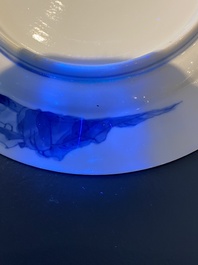 A Chinese blue and white plate with two men in a landscape, Kangxi