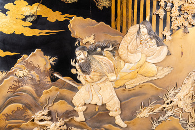 A large Japanese wooden screen with a central gilt-lacquered and ivory-inlaid panel, Meiji