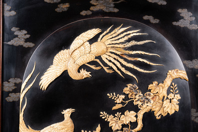 A large Japanese wooden screen with a central gilt-lacquered and ivory-inlaid panel, Meiji