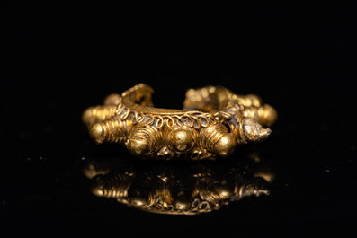 Three Vietnamese golden earrings, Champa, 14th C. and a pair of later Chinese gilded earrings, 18/19th C.