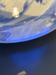 A Chinese blue and white plate with two men in a landscape, Kangxi