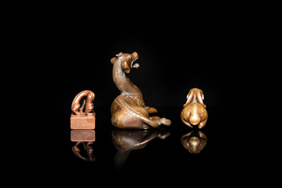 Two Chinese bronze scroll weights and a seal stamp, Qing