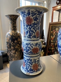 A Chinese blue, white and copper-red 'gu' vase with lotus scrolls, Kangxi
