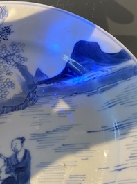 A Chinese blue and white plate with two men in a landscape, Kangxi