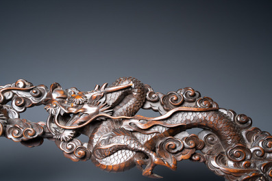 A large Japanese wooden screen with a central gilt-lacquered and ivory-inlaid panel, Meiji
