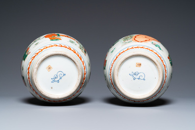 A pair of Chinese famille verte vases on wooden stands, 'hare' mark, 19th C.
