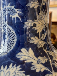 A pair of Chinese blue and white 'dragon and peony' vases, 19th C.
