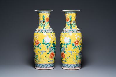 A pair of Chinese yellow-ground famille rose vases, 19th C.