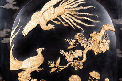 A large Japanese wooden screen with a central gilt-lacquered and ivory-inlaid panel, Meiji