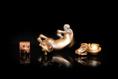 Two Chinese bronze scroll weights and a seal stamp, Qing
